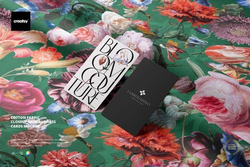 Close-up of green cotton fabric with colorful flowers, displaying two business cards on a detailed mockup scene.
