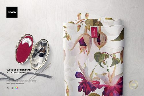 Close-up of a silk scarf mockup with a visible fabric label, featuring a floral pattern and soft colors.