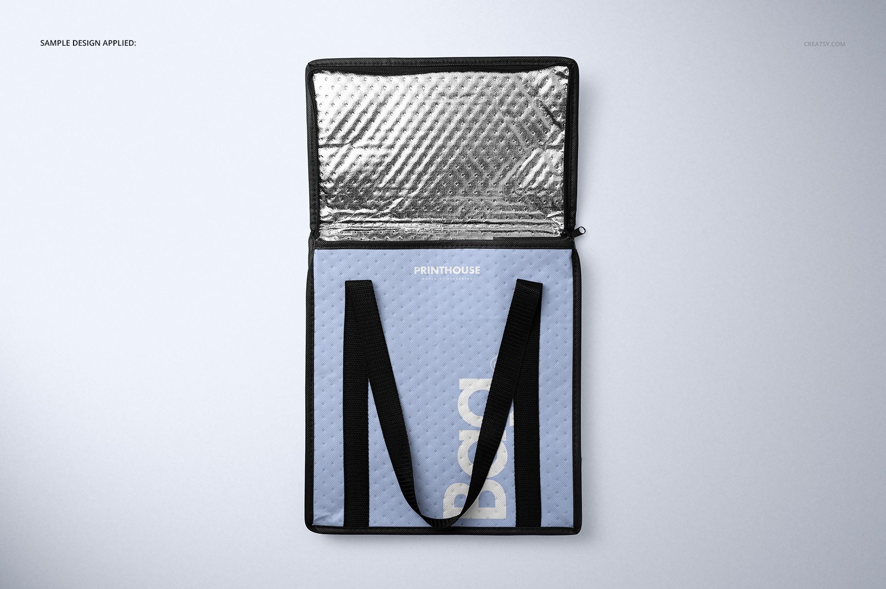 Front view of an insulated cooler bag mockup with open lid, showing silver lining and light blue exterior with black straps.