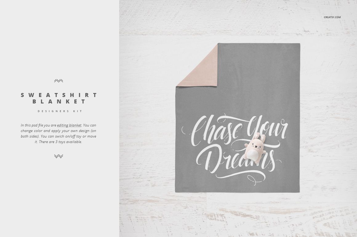 Gray crib bedding mockup with white script text and plush toy on a light wooden surface, top view.