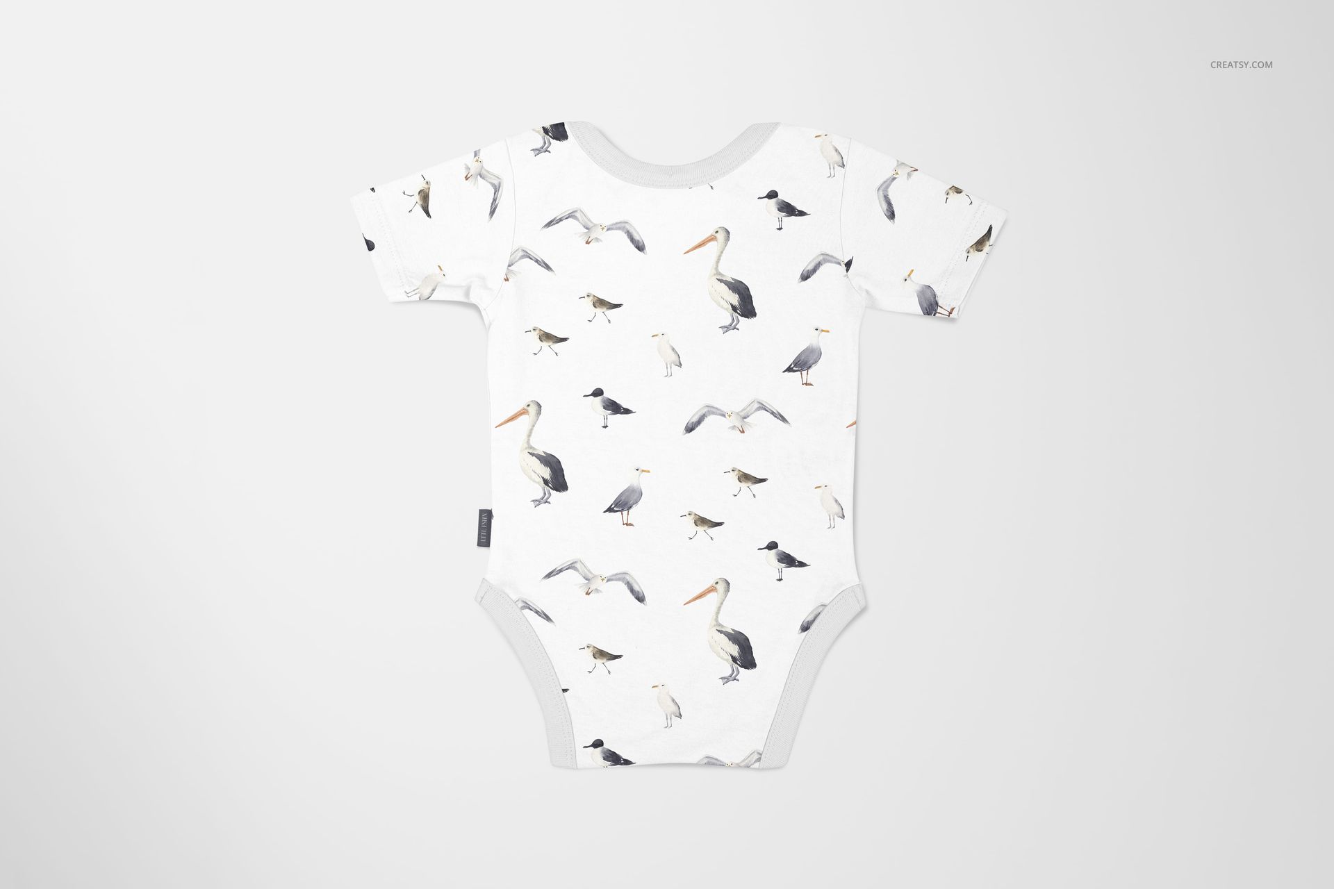 Front view of a baby onesie mockup with a bird pattern, displayed on a light background with subtle shadows.