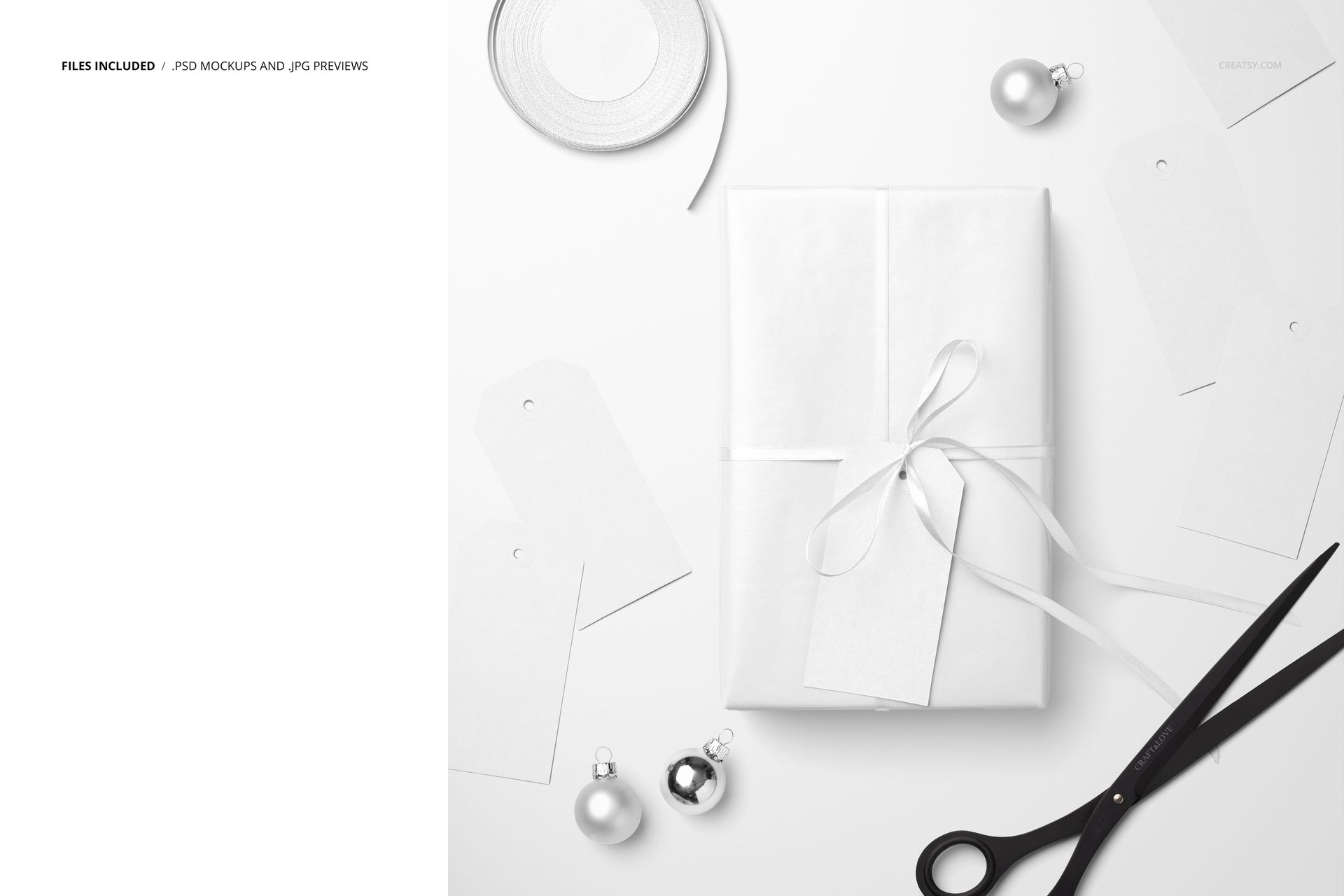 Christmas gift mockup featuring a white box with ribbon, paper labels, metallic baubles, and scissors on a table.