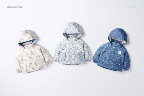 Kids rainwear PSD mockup set showing three hooded jackets in varied blue and cream colors, arranged side by side.