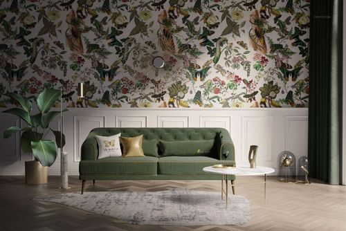 Front view of a retro living room mockup featuring a green sofa, patterned wall, custom rug, and gold accents.