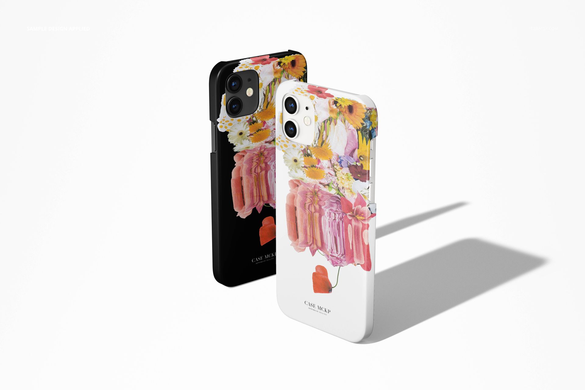 PSD mockup of iPhone 12 matte snap cases in black and white, decorated with vibrant floral artwork, casting shadows.