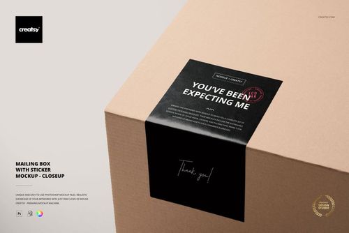 PSD mockup of a packaging box with a black sticker on the top surface, highlighted in a closeup scene against a light background.