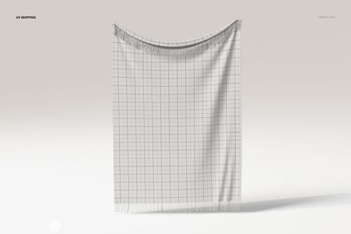 Front view of a fringed tapestry blanket with a grid pattern, displayed against a light neutral background.