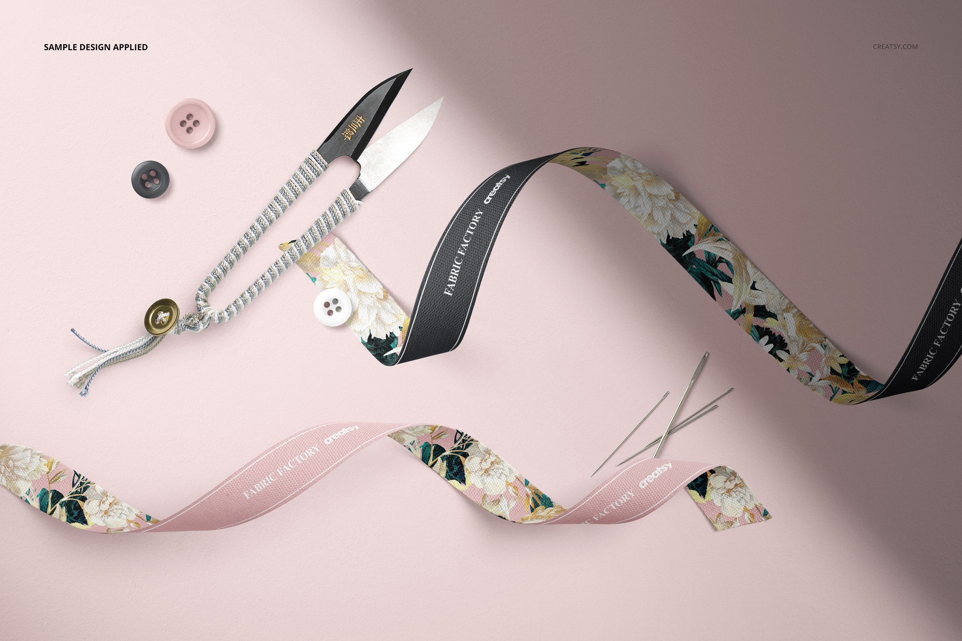 Thread snips and cotton ribbons mockup featuring floral patterns and text, surrounded by buttons and needles, top view.