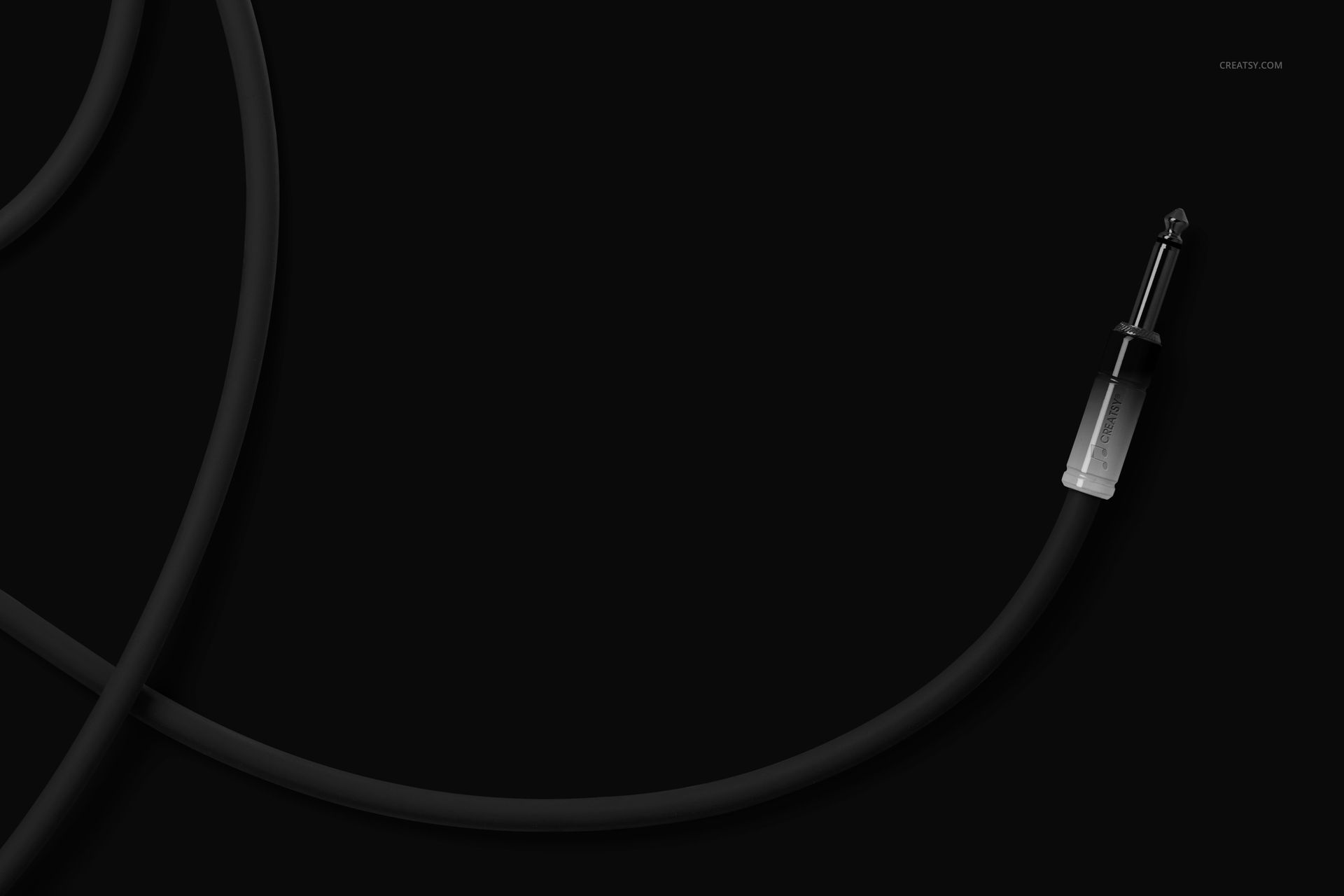 Isolated black jack cable mockup featuring a metal connector, presented on a solid black background in top view.