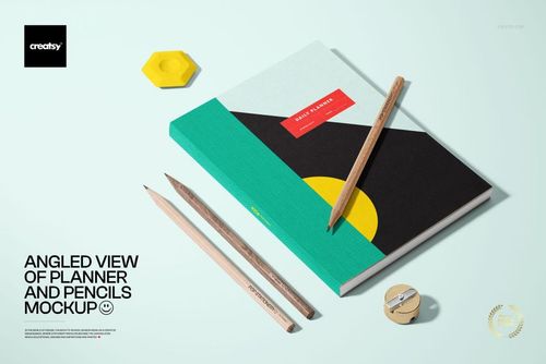 Stationery mockup featuring a closed planner with colorful geometric shapes and three pencils arranged on a light surface.