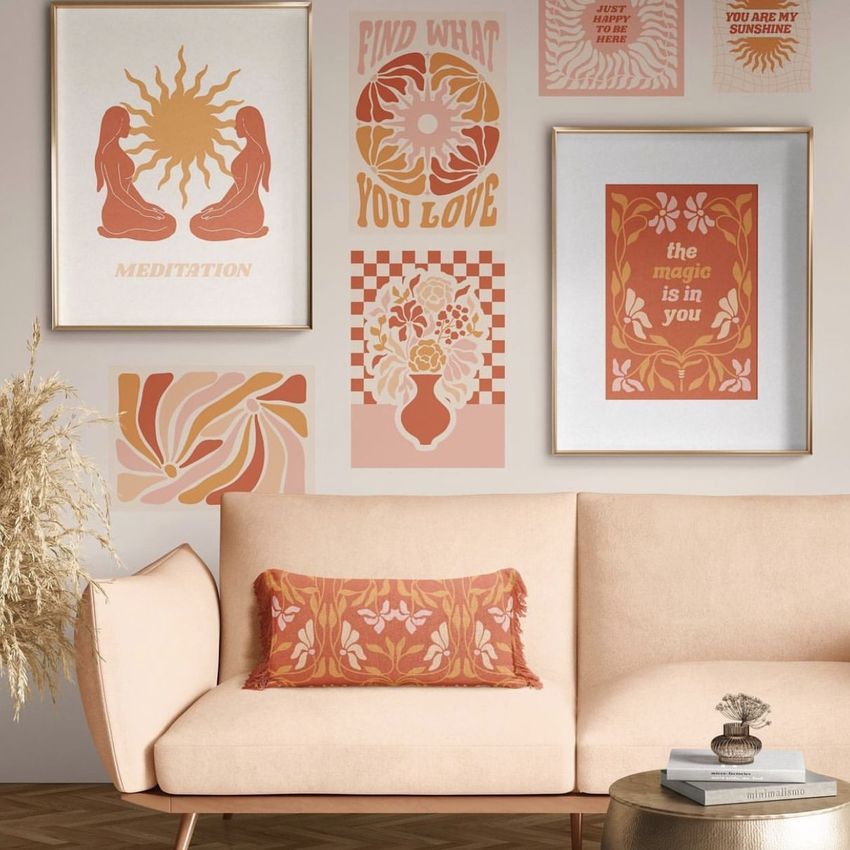 Interior poster mockup showing framed and unframed prints with retro designs in warm tones above a beige sofa with a patterned pillow.