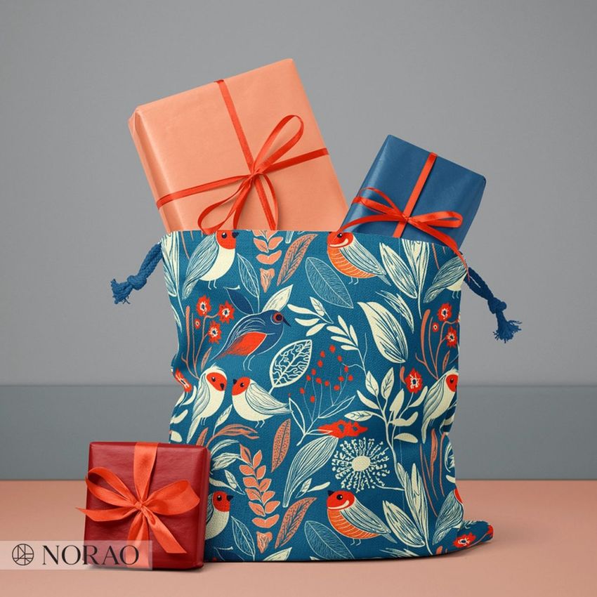 Santa bag mockup with a blue and red bird pattern, filled with wrapped presents, set against a plain gray background.