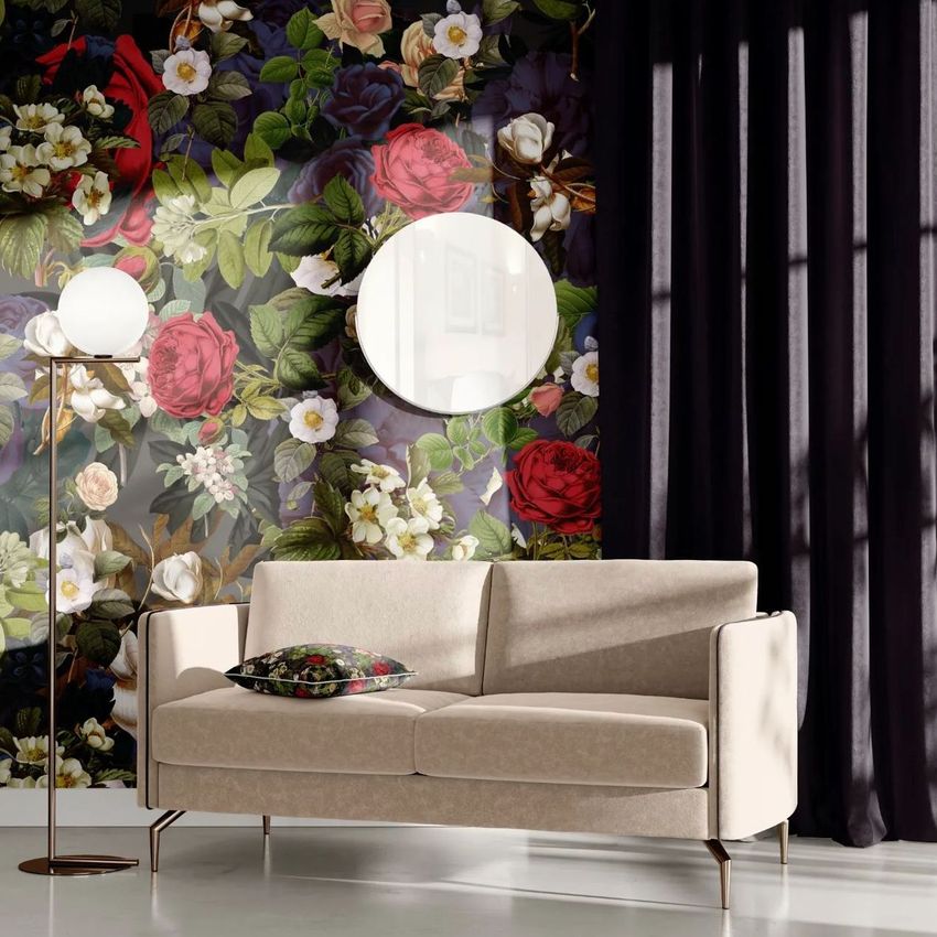 Living room scene mockup with a beige sofa, floral accent pillow, round mirror, and bold floral wallpaper behind.