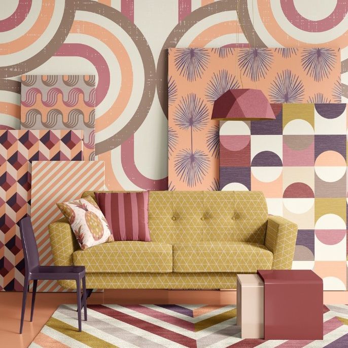 Modern sofa mockup scene with a yellow geometric sofa, patterned pillows, and abstract wall art in pastel tones.