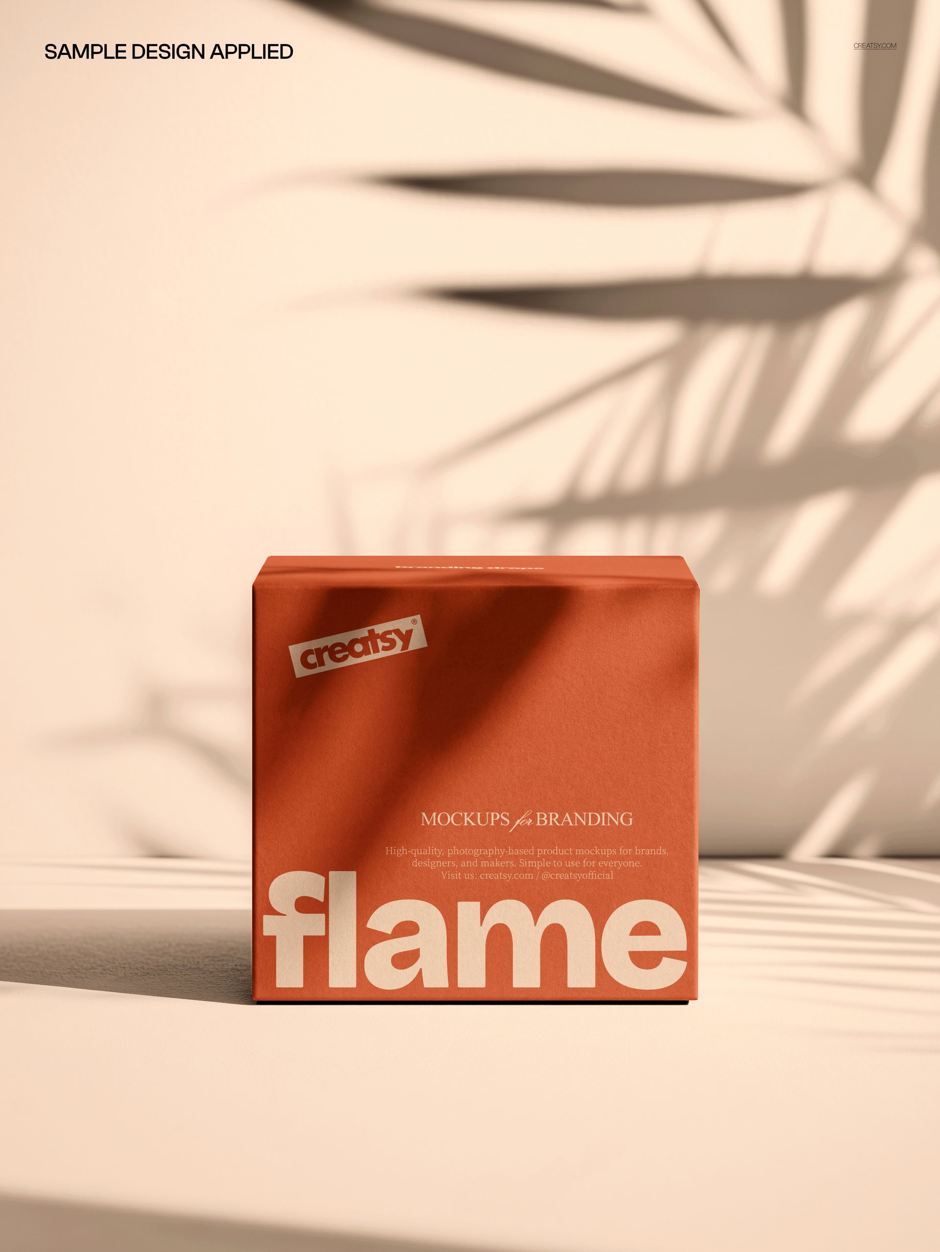 Square packaging box mockup in earthy orange, set against a beige wall with soft botanical leaf shadows.