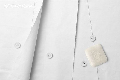 Fanned arrangement of white cotton fabric with visible buttons and a soap bar, presented as a PSD mockup.