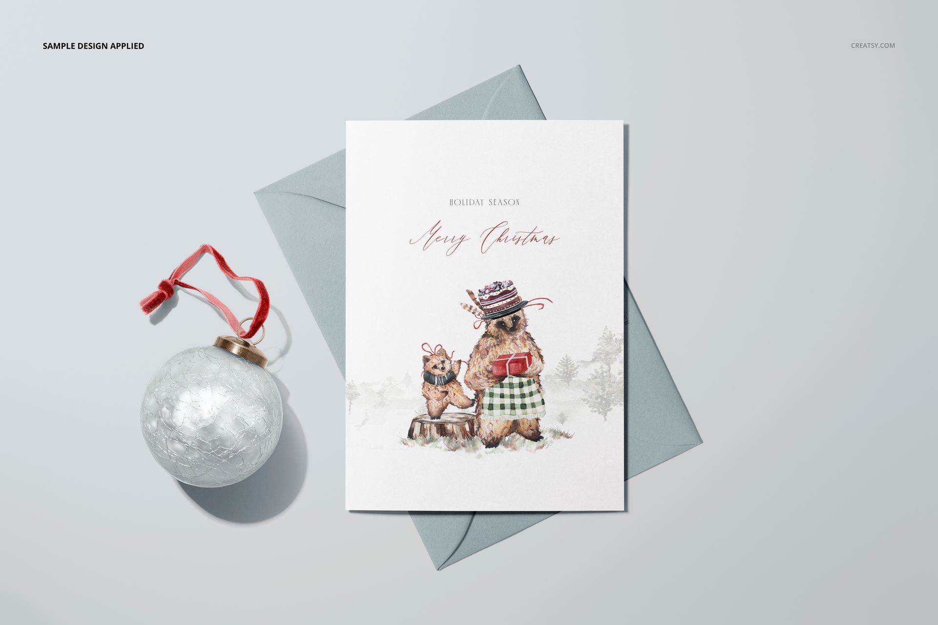 Front view of a 5x7 greeting card mockup with illustrated bears in winter attire, placed on a gray envelope.