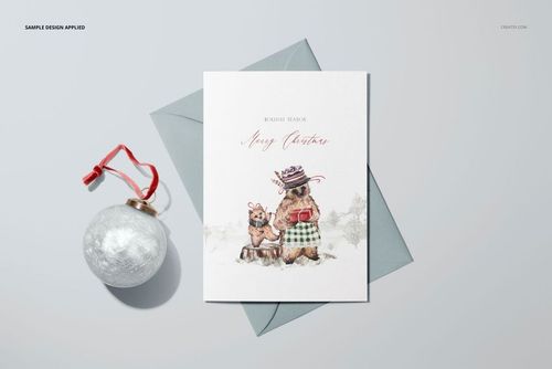 Front view of a 5x7 greeting card mockup with illustrated bears in winter attire, placed on a gray envelope.