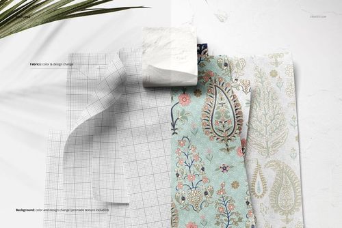 Front view of cotton fabric swatches featuring a white grid design and colorful paisley prints pinned to a wall mockup.