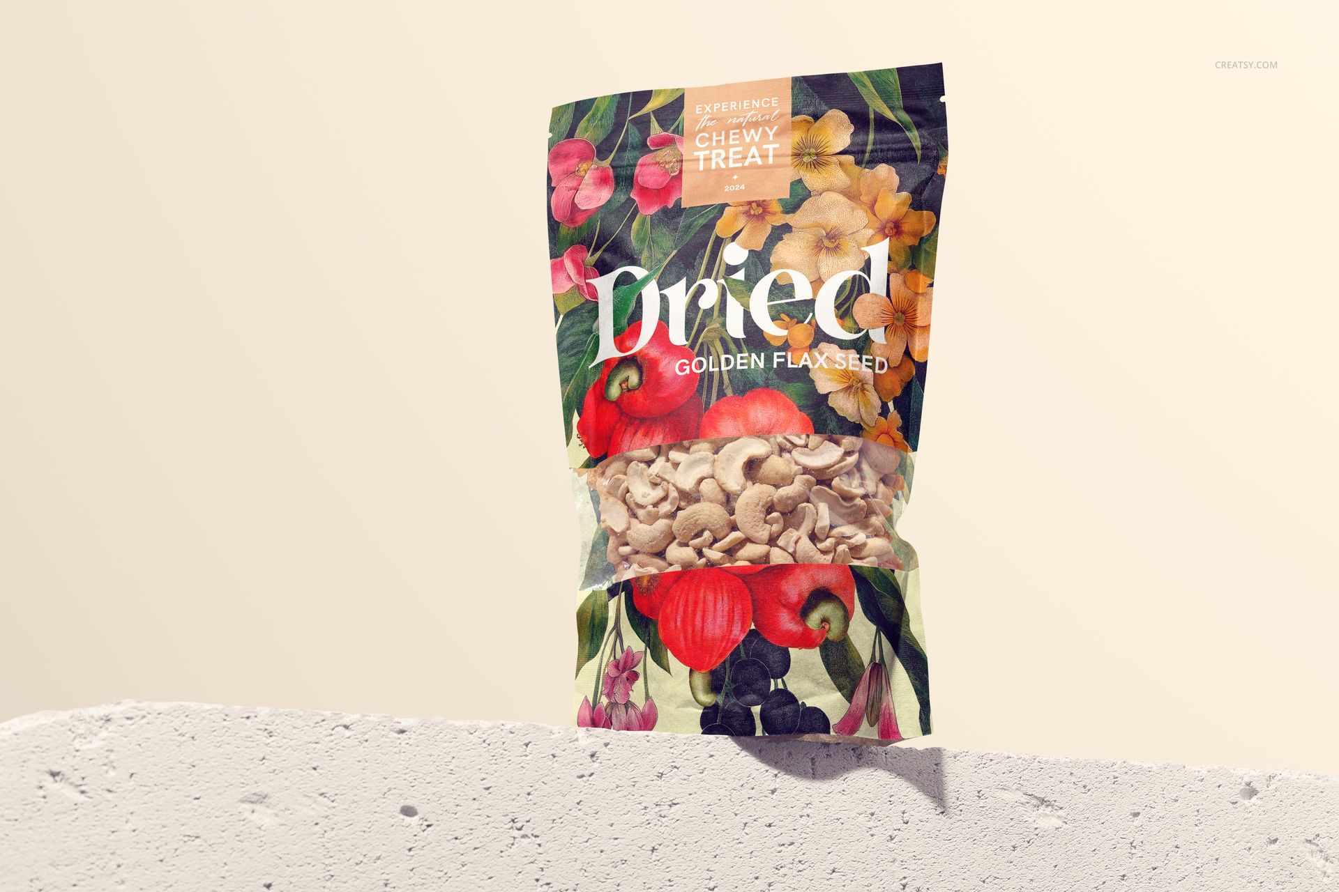Paper pouch mockup standing upright on a light textured surface, decorated with vibrant botanical patterns and cashews visible.