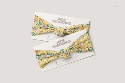 PSD mockup showing a pair of kids headbands with a knotted center, decorated with colorful jungle motifs on a light background.