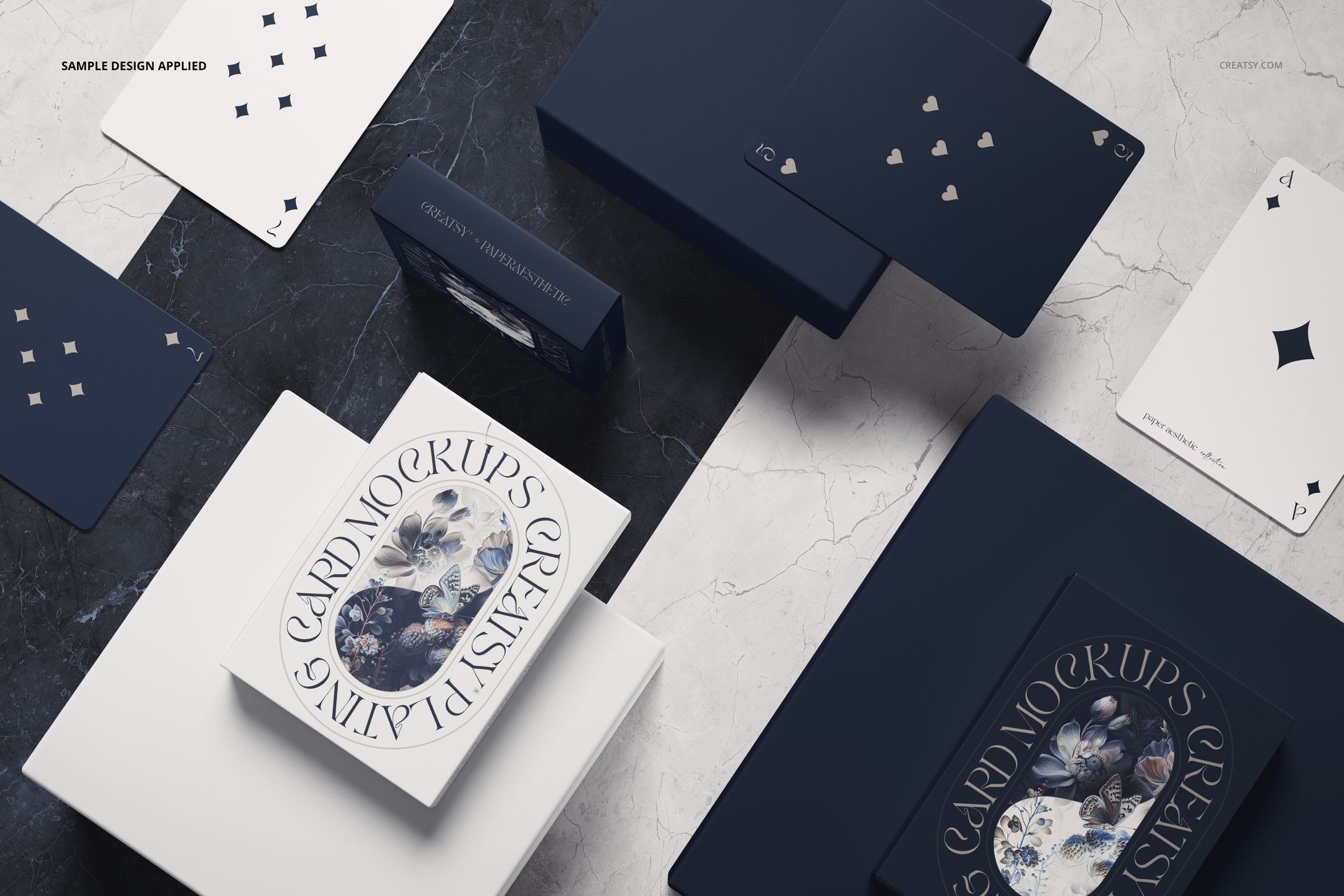 Playing cards and packaging mockup displayed on a marble surface, featuring navy and white color scheme.