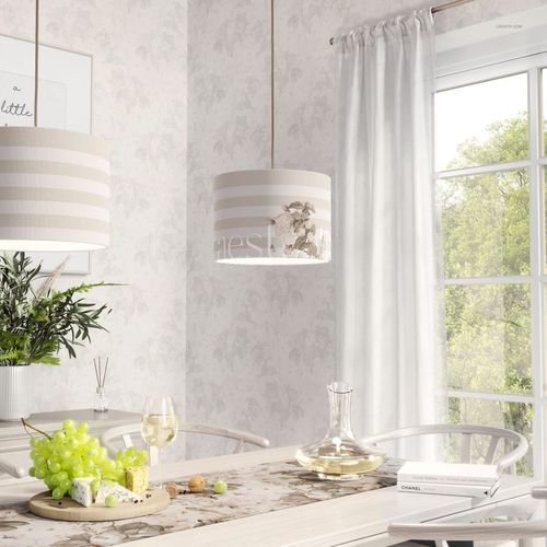 Cylindrical lamp shade mockup with soft beige stripes and floral accents, suspended over a dining table setting.