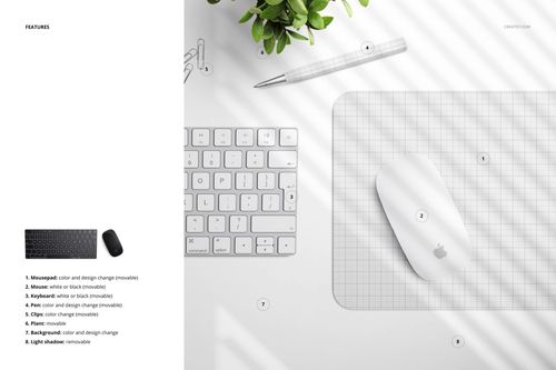 Rectangular mouse pad mockup with grid design, shown beside a white keyboard, mouse, pen, and potted plant from above.