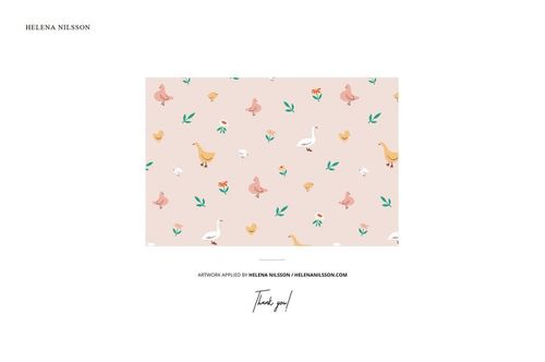 PSD mockup of folded jersey fabric featuring ducks, swans, flowers, and leaves in soft tones, arranged on a flat surface.