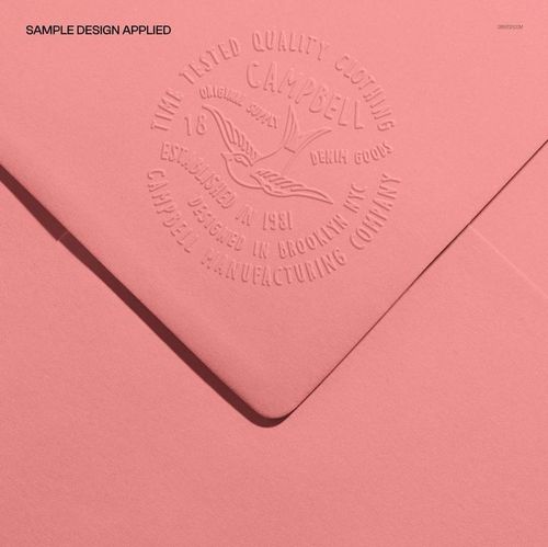 Pink stationery envelope mockup featuring embossed branding details, captured in a detailed top-down perspective.