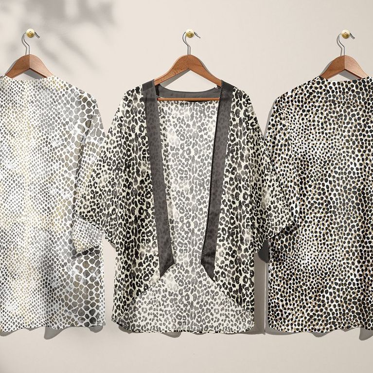 Chiffon kimono mockup featuring three garments on wooden hangers, each with a different animal print pattern on a neutral wall.