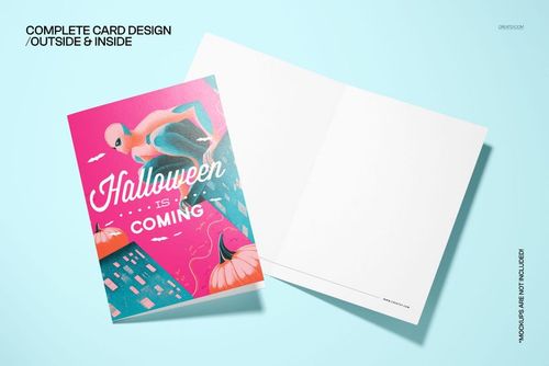 Folded 5x7 card mockup with a vintage Halloween superhero illustration on the cover, shown on a light blue surface.