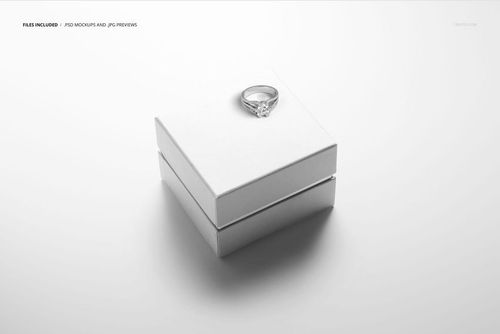 Square jewelry box mockup in white, shown from a top angle with a silver ring placed on the closed lid.
