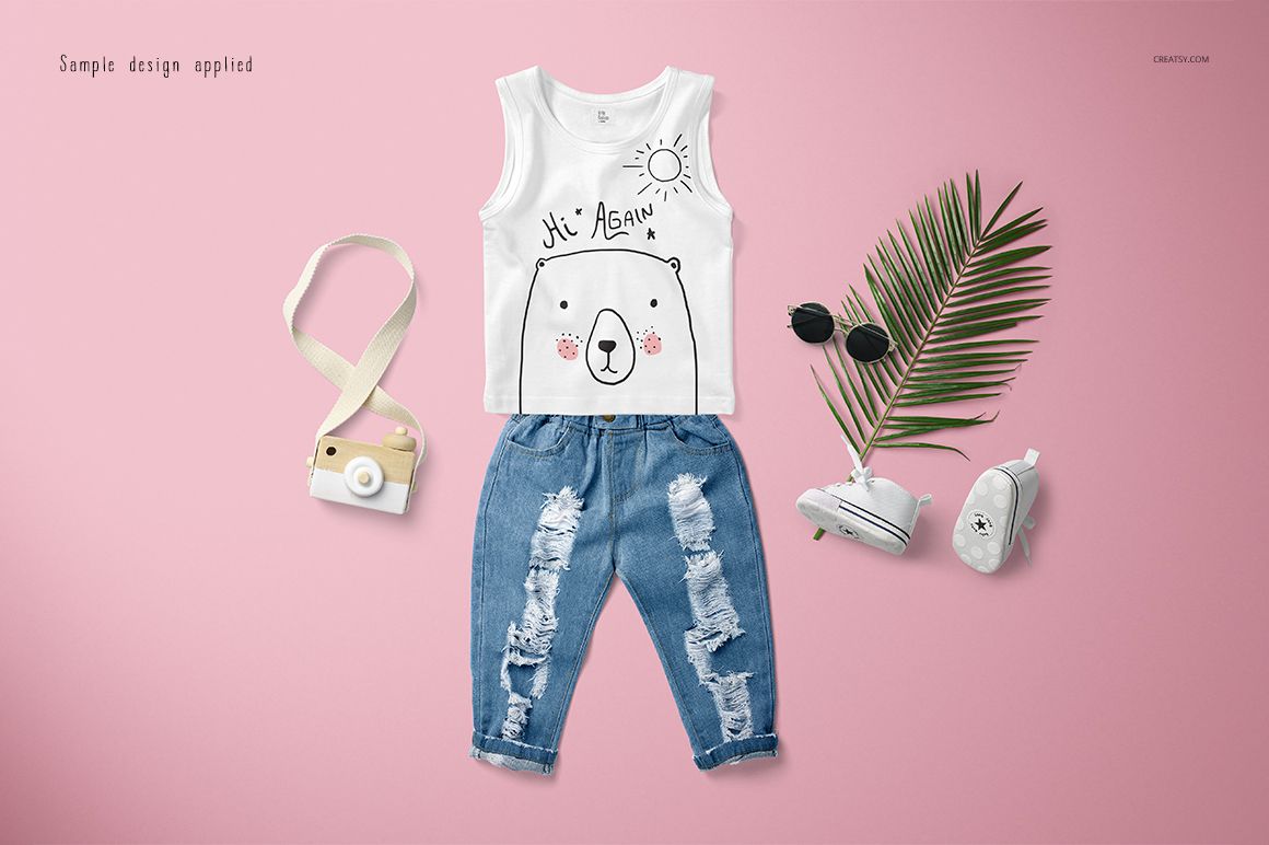 Front view of a baby tank top mockup paired with distressed jeans, surrounded by playful accessories on a pink background.