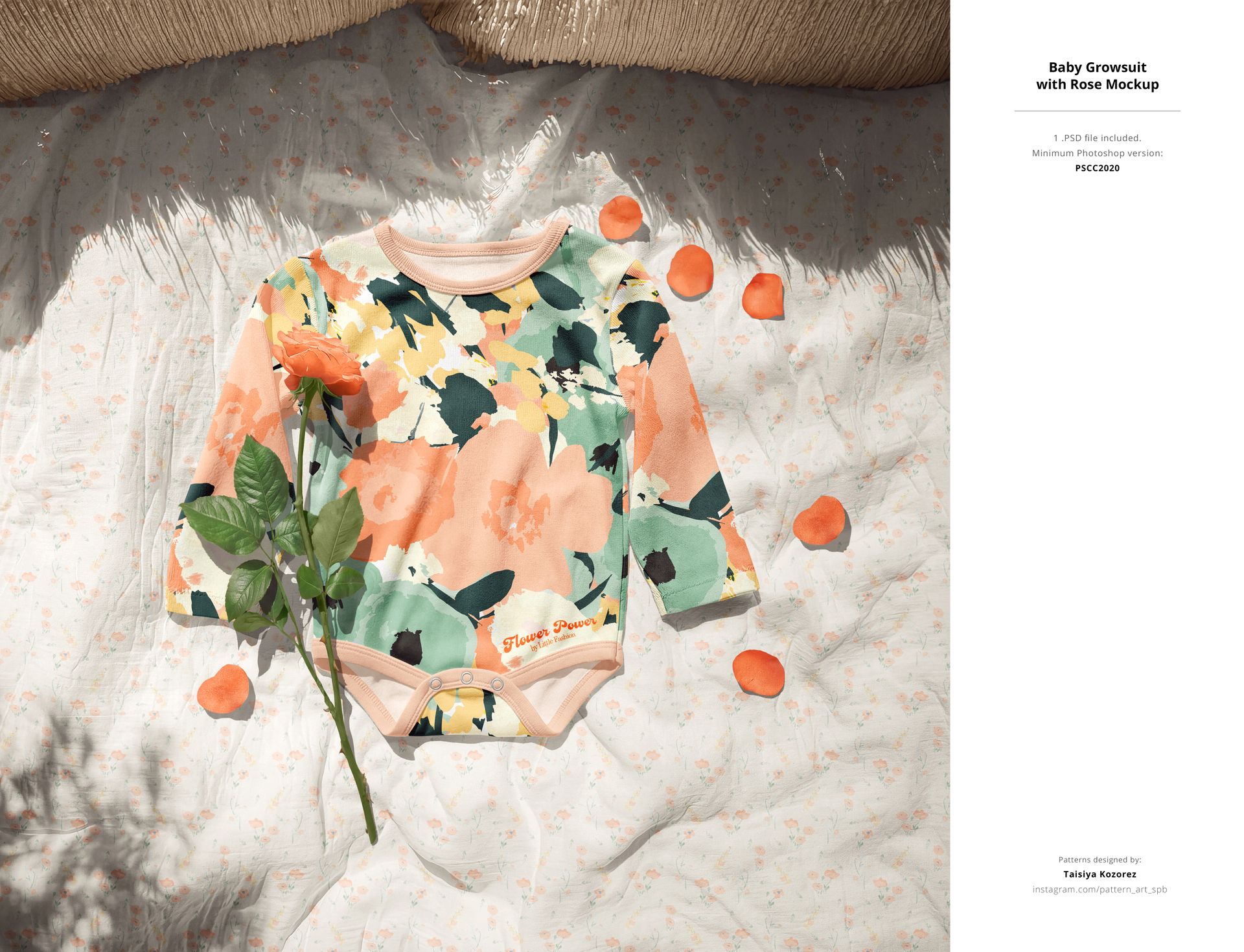 Front view of a floral patterned baby bodysuit mockup on a light blanket, surrounded by rose petals and a single rose stem.