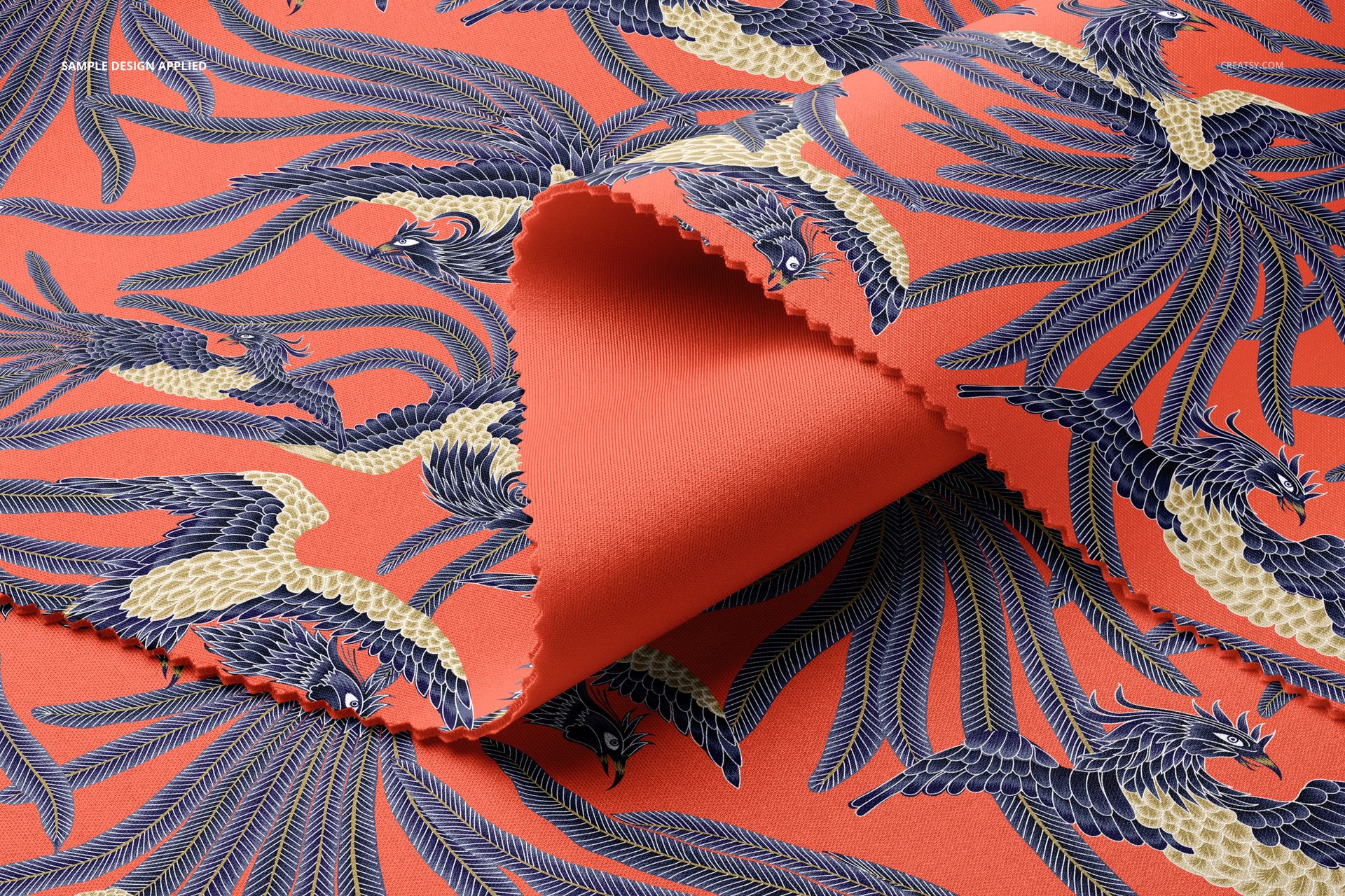 Scuba fabric mockup featuring folded textile with a bold orange background and intricate blue and cream bird pattern.