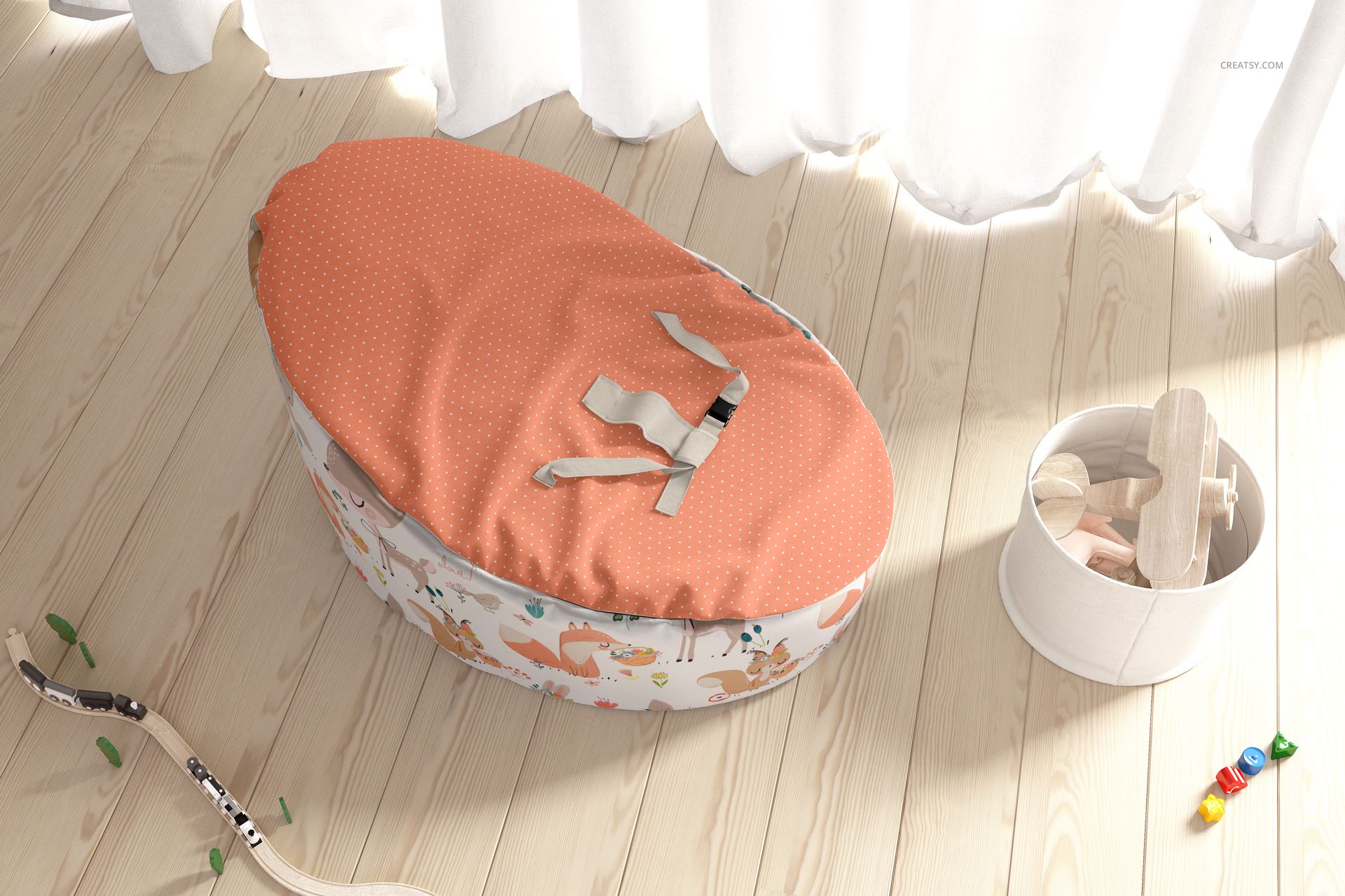 Oval-shaped baby bean bag mockup featuring soft orange cover and playful animal pattern, front view in nursery setting.