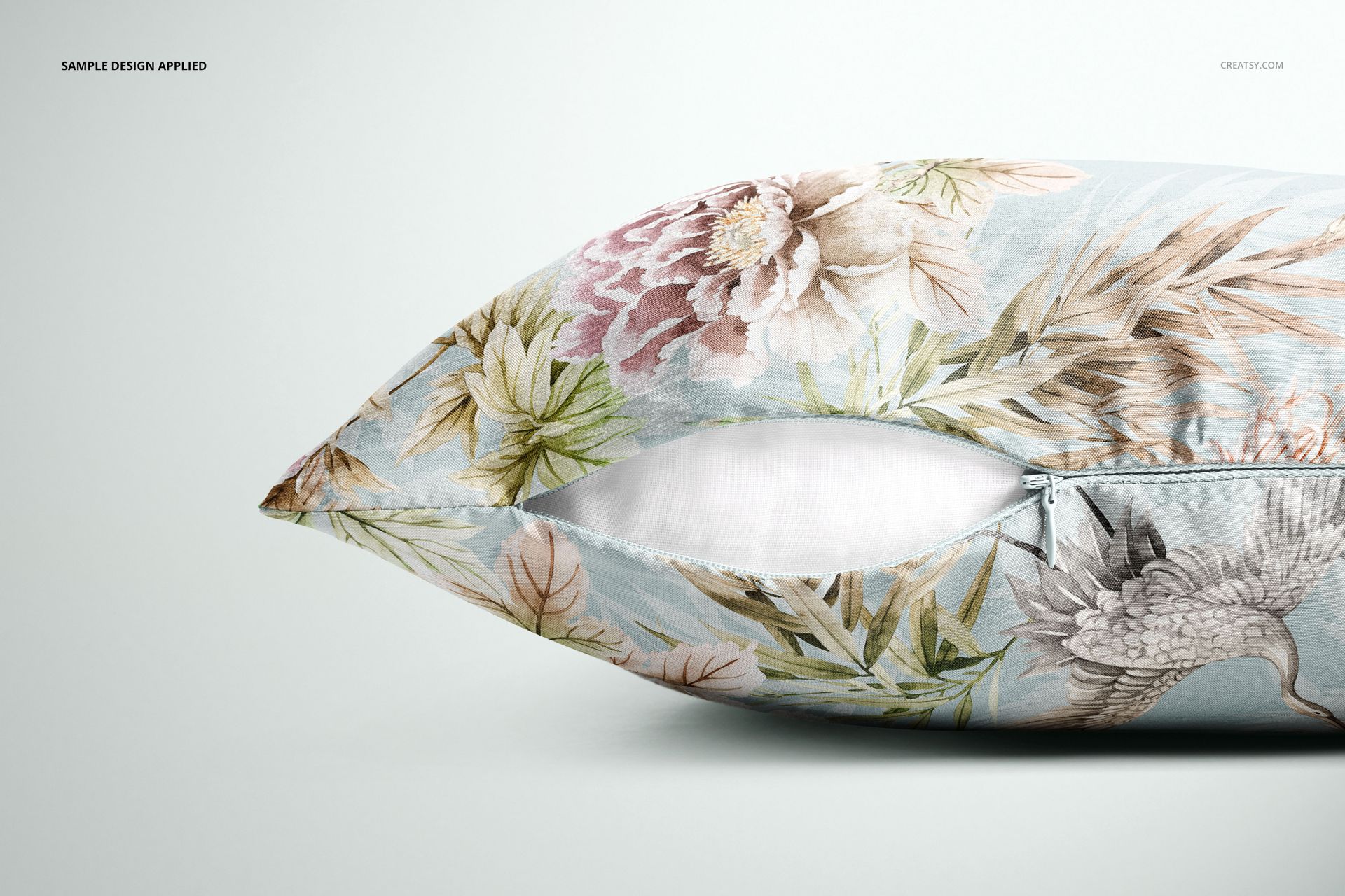 PSD mockup of a cushion cover featuring soft blue background, botanical motifs, and a visible zipper on the side.