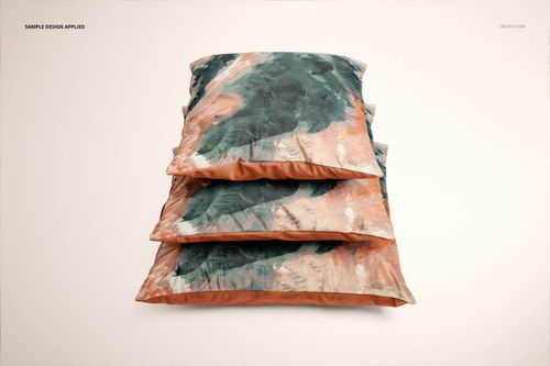 PSD mockup showing three velvet cushion covers with a watercolor-style design in green, peach, and beige, stacked neatly.
