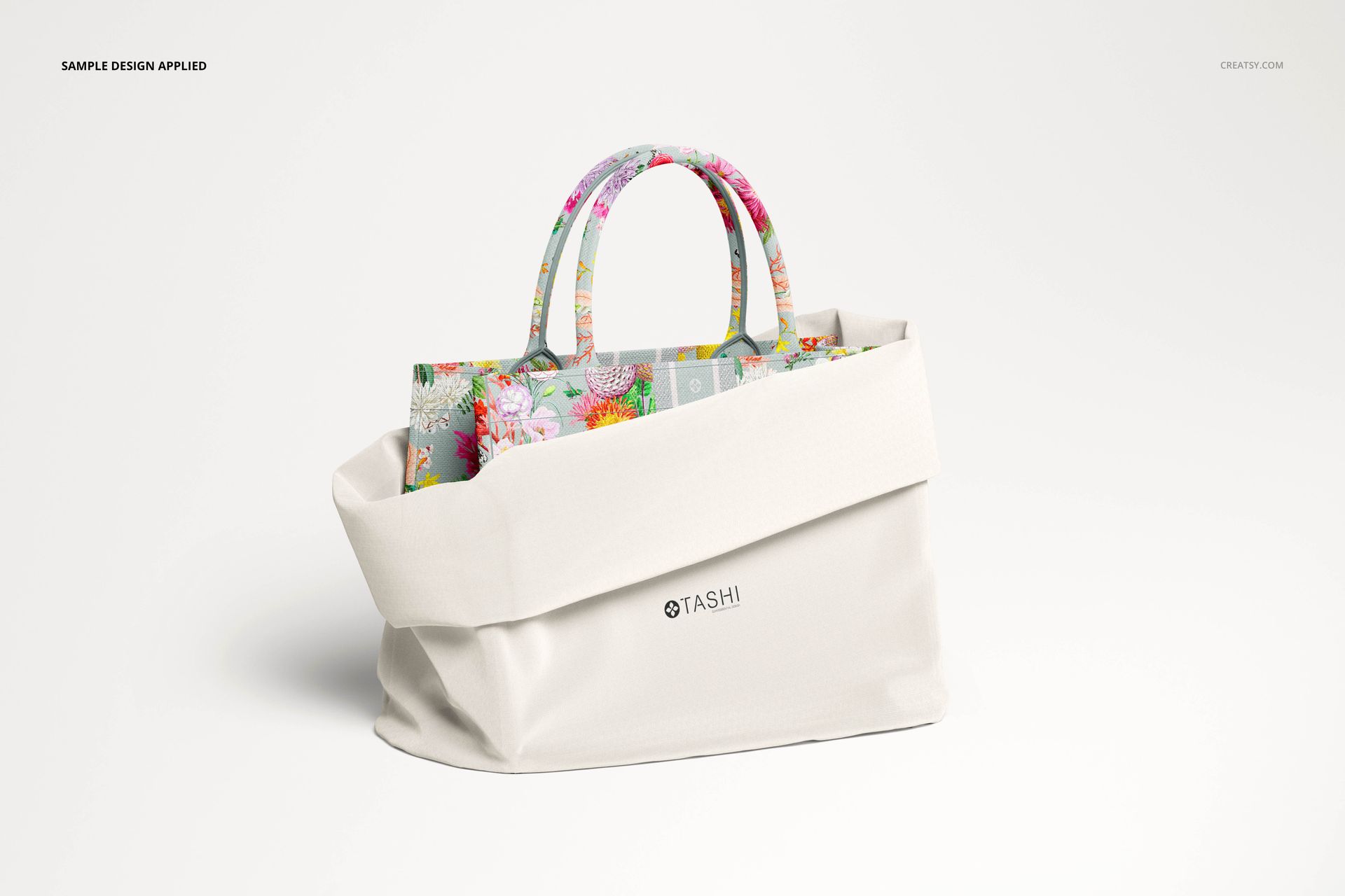 Canvas tote bag PSD mockup showing a white exterior, floral patterned handles, and a matching inner lining.