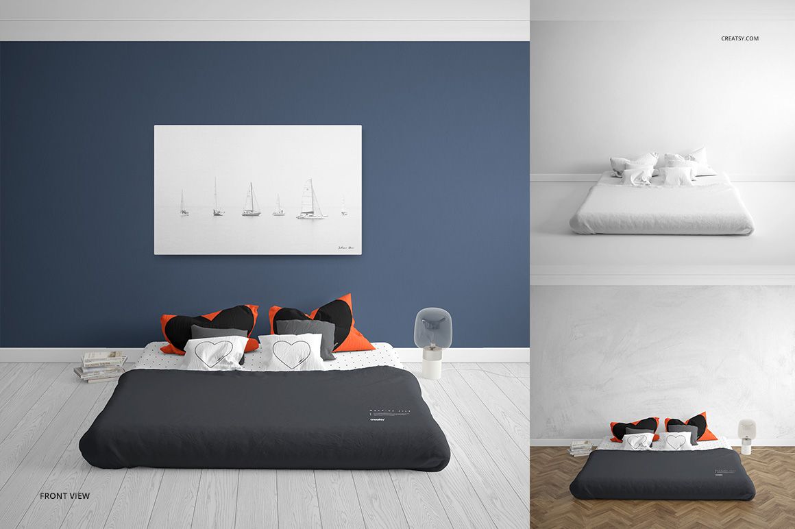 Front view of a bedroom mockup set featuring a bed with dark bedding, orange and black pillows, and a white wall art piece.