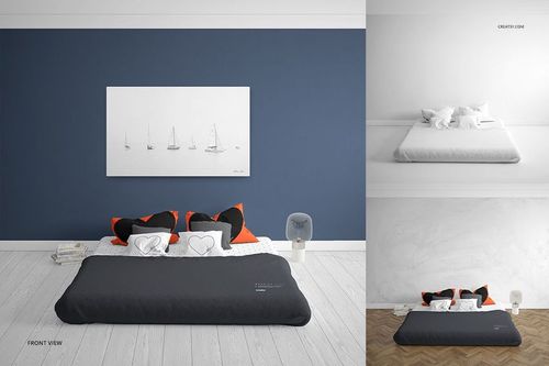 Front view of a bedroom mockup set featuring a bed with dark bedding, orange and black pillows, and a white wall art piece.