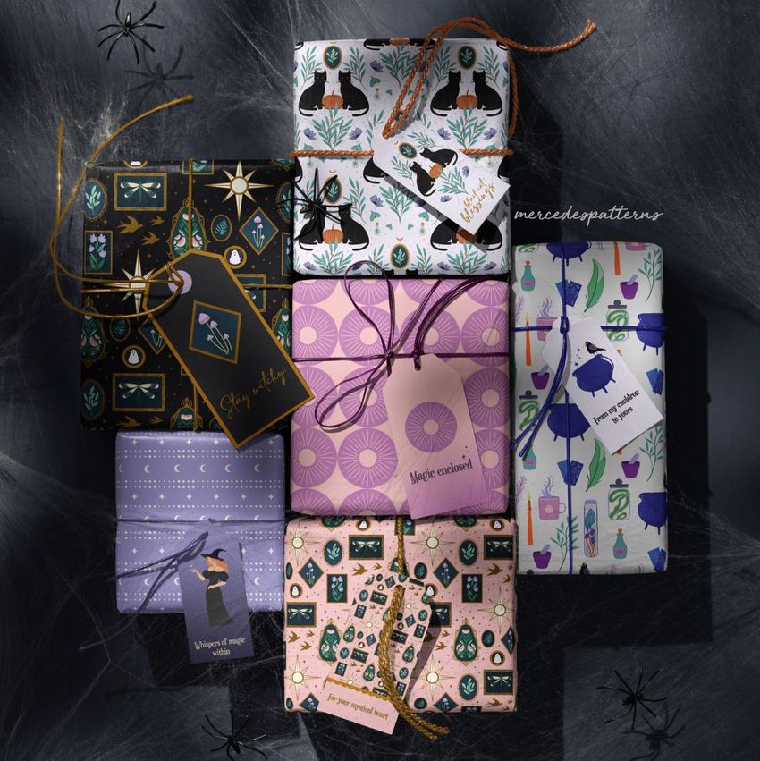 Halloween gift wrap boxes mockup featuring eight boxes with various spooky patterns, tags, and a dark textured background.