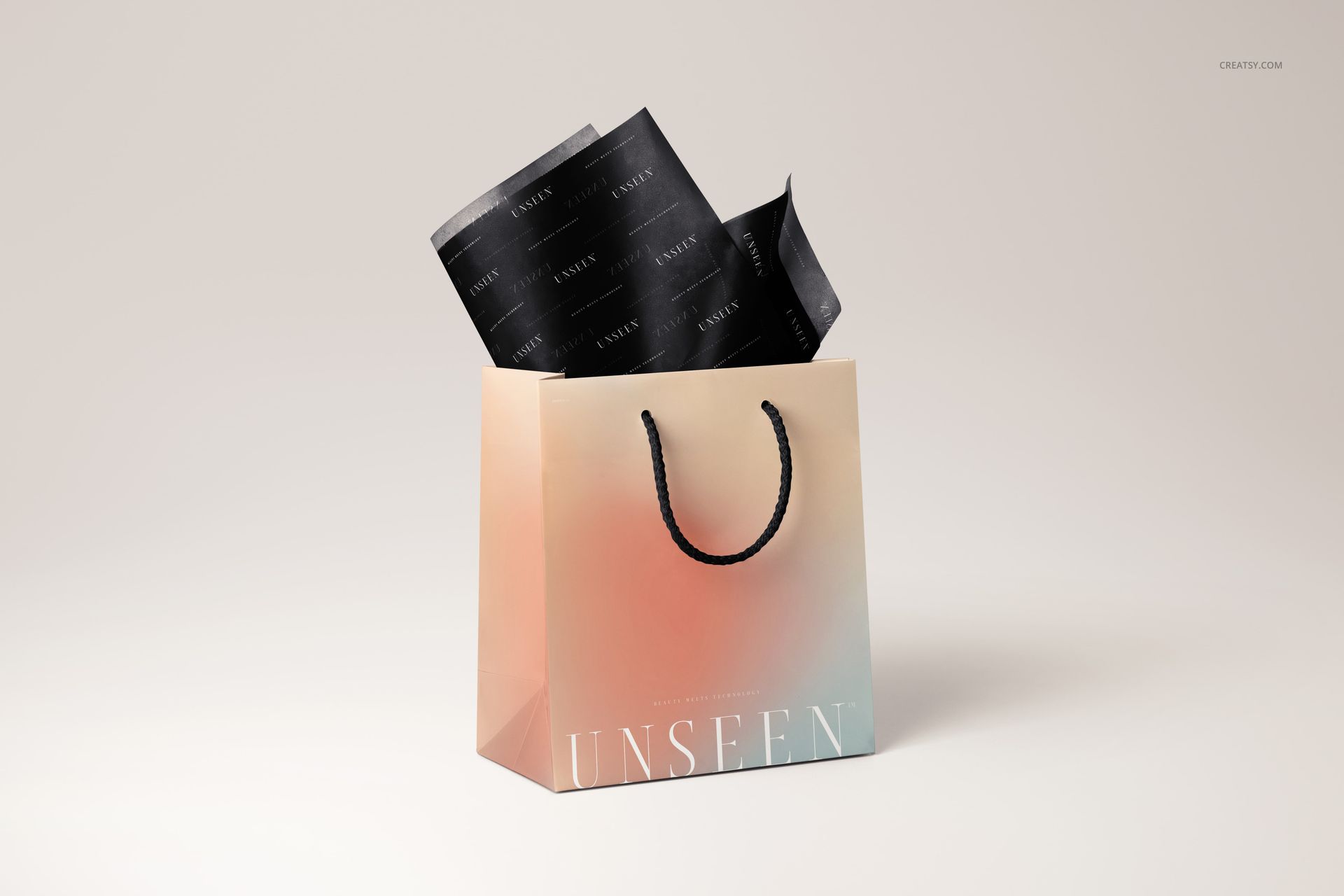 Gift bag mockup featuring a soft gradient design and black twisted handles, with branded black tissue paper inside.