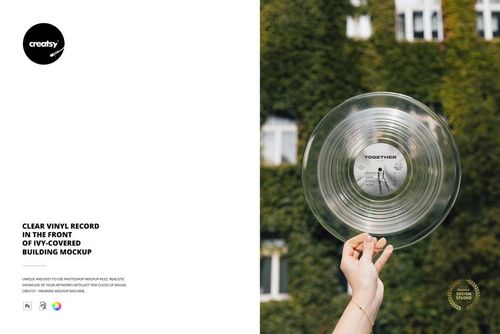 Transparent vinyl record mockup held up against a background of ivy-covered building and windows outdoors.
