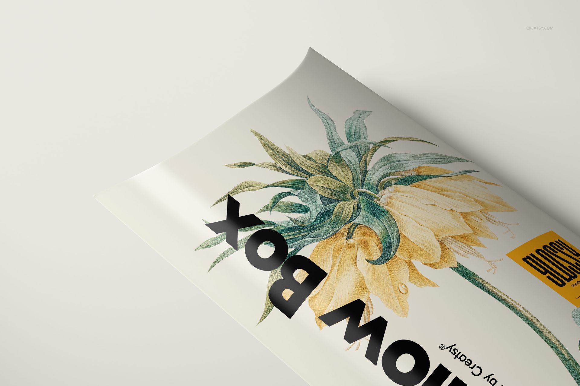 Mockup of a pillow box with a botanical pattern, displayed in close-up from a slanted perspective.