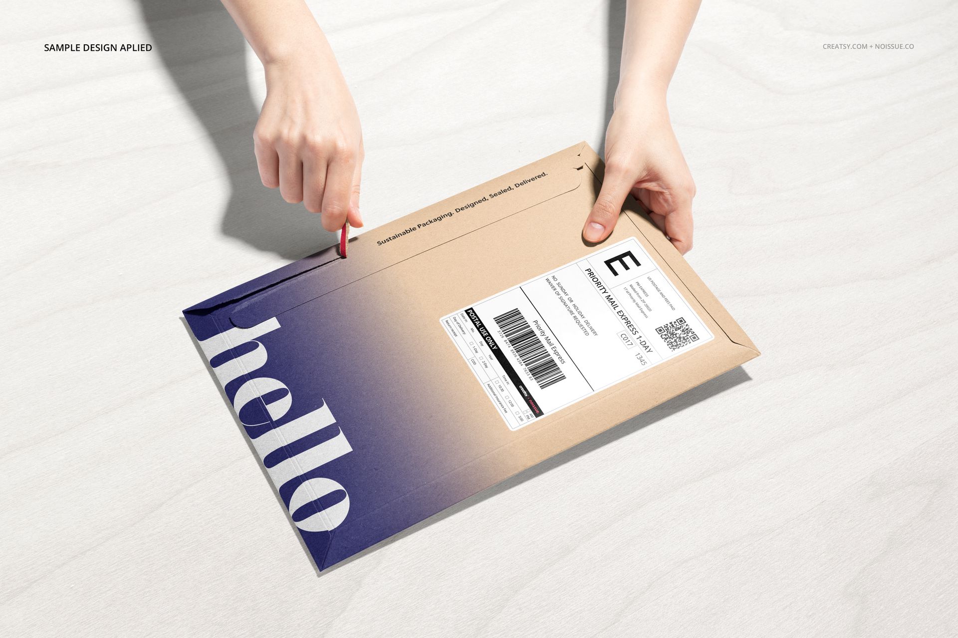 Noissue Shipping Labels Mockup shows a kraft mailer with blue and white label, hands pulling tab, on pale wood background.