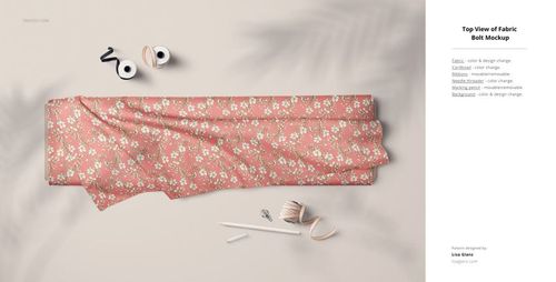 PSD mockup showing a floral patterned fabric bolt, sewing tools, and subtle leaf shadows on a neutral surface.