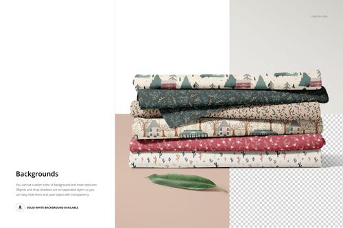Fabric stack mockup featuring assorted patterns and shades, displayed on a light surface with a leaf prop.