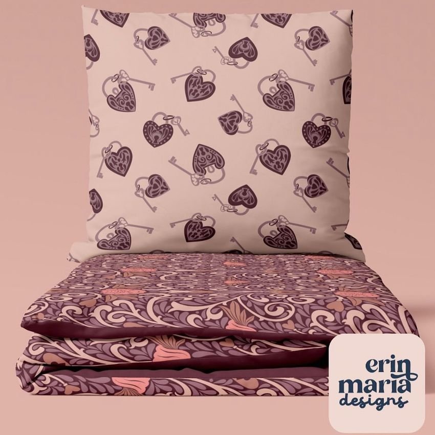 Bedding set mockup featuring a pillow and folded duvet with heart and key patterns in pink and burgundy tones on a plain background.